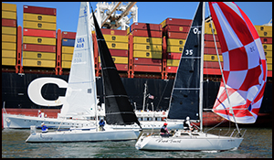 Two sailboats, the Potomac and a container ship